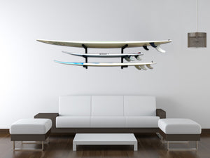 Wall mounted surfboard racks in house powder coated black to hold 3 surfboards 